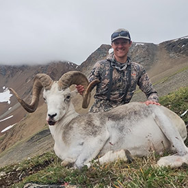 Hunter holding a Stone's sheep
